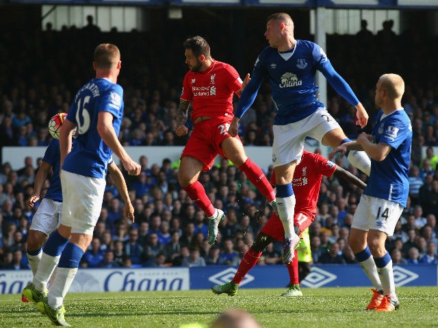 Danny Ings of Liverpool scores Liverpool's first goal during the Barclays Premier League match between Everton and Liverpool at Goodison Park on October 4, 2015 in Liverpool, England.