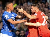 Liverpool's English midfielder James Milner (2R) holds Liverpool's German midfielder Emre Can (R) back from Everton's Zimbabwean midfielder Brendan Galloway (L) during a scuffle during of the English Premier League football match between Everton and Liver