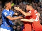 Liverpool's English midfielder James Milner (2R) holds Liverpool's German midfielder Emre Can (R) back from Everton's Zimbabwean midfielder Brendan Galloway (L) during a scuffle during of the English Premier League football match between Everton and Liver