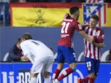 Luciano Dario Vietto (R) of Atletico de Madrid celebrates scoring their opening goal with teammate Yannick Carrasco (2ndR) as Luka Modric (R) of Real Madrid CF recats during the La Liga match between Club Atletico de Madrid and Real Madrid CF at Vicente C