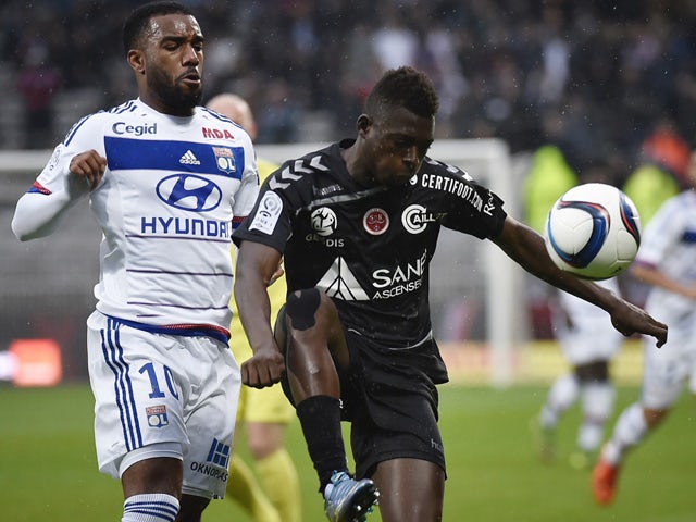 Lyon's French forward Alexandre Lacazette (L) vies with Reims' Malian defender Hamari Traore (R) during the French L1 football match between Olympique Lyonnais (OL) and Reims on October 3, 2015