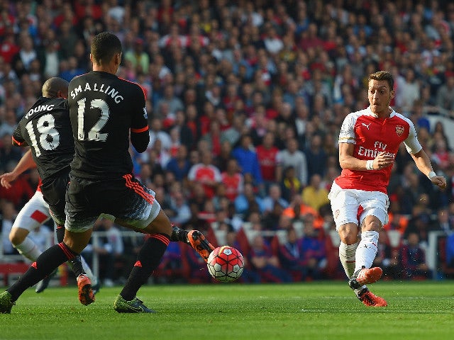Mesut Oezil of Arsenal scores Arsenal 2nd goal during the Barclays Premier League match between Arsenal and Manchester United at Emirates Stadium on October 4, 2015 in London, England.