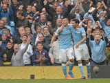 Manchester City's Argentinian striker Sergio Aguero (L) celebrates with Manchester City's Spanish midfielder Jesus Navas after scoring his third goal during the English Premier League football match between Manchester City and Newcastle United at The Etih