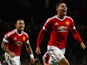Chris Smalling of Manchester United (R) celebrates with team mate Memphis Depay as he scores their second goal during the UEFA Champions League Group B match between Manchester United FC and VfL Wolfsburg at Old Trafford on September 30, 2015