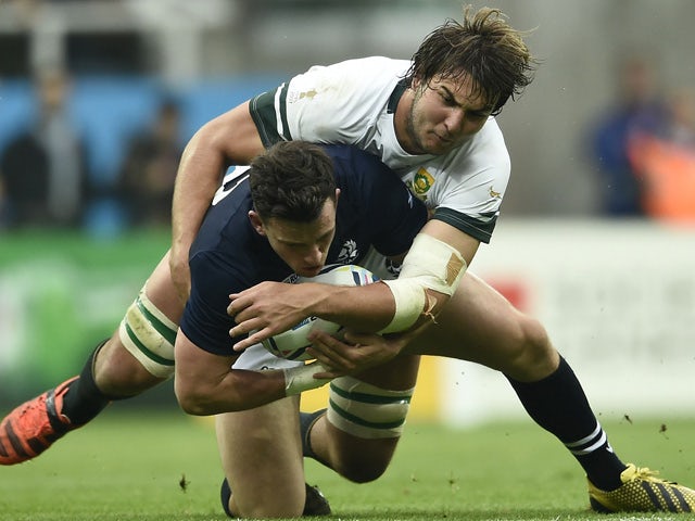 Scotland's centre Matt Scott (L) is tackled by South Africa's lock Lood de Jager during a Pool B match of the 2015 Rugby World Cup between South Africa and Scotland at St James' Park in Newcastle-upon-Tyne, north east England on October 3, 2015