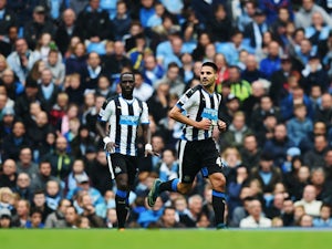 Aleksandar Mitrovic (R) of Newcastle United celebrates scoring his team's first goal during the Barclays Premier League match between Manchester City and Newcastle United at Etihad Stadium on October 3, 2015