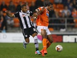 Nile Ranger of Blackpool holds off a challenge from Ikechi Anya of Watford during the Sky Bet Championship match between Blackpool and Watford at Bloomfield Road on September 16, 2014 in Blackpool, England.