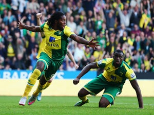 Dieumerci Mbokani (L) of Norwich City celebrates scoring his team's first goal during the Barclays Premier League match between Norwich City and Leicester City at Carrow Road on October 3, 2015