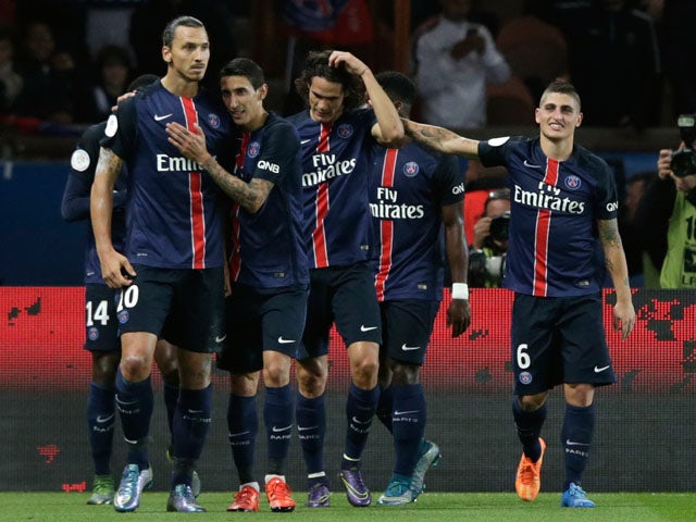 Paris Saint-Germain's Swedish forward Zlatan Ibrahimovic (L) is congratulated by teammates after scoring a penatly during the French L1 football match Paris Saint-Germain (PSG) vs Olympique de Marseille (OM) on October 4, 2015