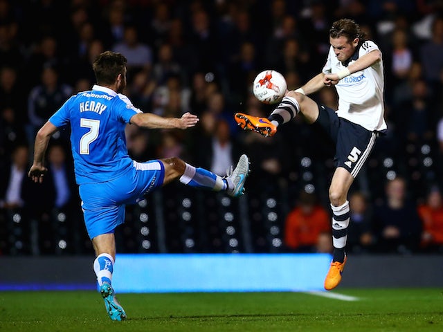 Richard Stearman of Fulham and James Henry of Wolves compete in the air for the ball during the Sky Bet Football League Championship match between Fulham and Wolverhampton Wanderers at Craven Cottage on September 29, 2015 in London, England.