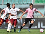 Franco Vazquez (R) of Palermo is challenged by Radja Nainggolan (C) and Miralem Pjanic of Roma during the Serie A match between US Citta di Palermo and AS Roma at Stadio Renzo Barbera on October 4, 2015 in Palermo, Italy.
