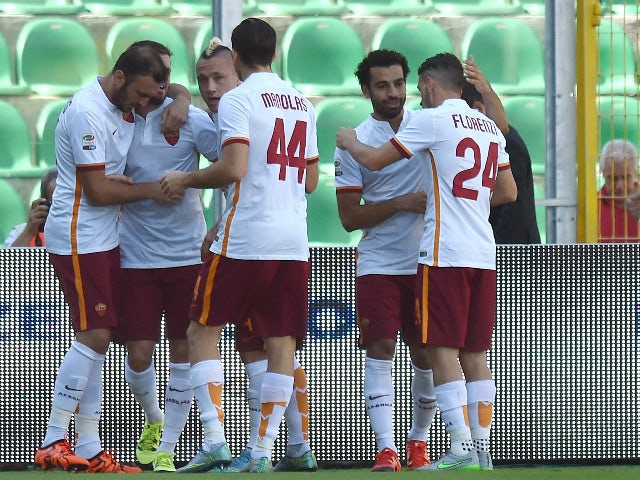 Miralem Pjanic of Roma celebrates with team mates after scoring the opening goal during the Serie A match between US Citta di Palermo and AS Roma at Stadio Renzo Barbera on October 4, 2015 in Palermo, Italy. 