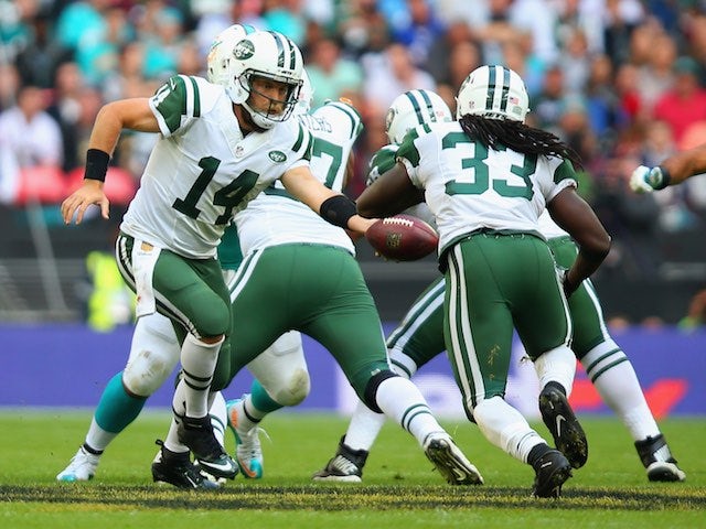 Ryan Fitzpatrick hands off to New York Jets teammate Chris Ivory during the game with Miami Dolphins at Wembley on October 4, 2015