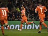 Valencia's Algerian midfielder Sofiane Feghouli (C) celebrates after scoring a goal during the Champions League group H football match between Lyon and Valencia on September 29, 2015 at the Gerland stadium in Lyon, central-eastern France.