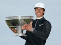 Thorbjorn Olesen of Denmark holds the trophy aloft on the Swilcan Bridge on the 18th hole after victory in the 2015 Alfred Dunhill Links Championship at The Old Course on October 4, 2015
