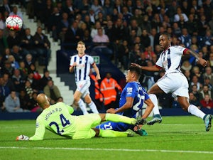 Saido Berahino of West Bromwich Albion beats goalkeeper Tim Howard and Tyias Browning of Everton to score their first goal during the Barclays Premier League match between West Bromwich Albion and Everton on September 28, 2015 in West Bromwich, United Kin