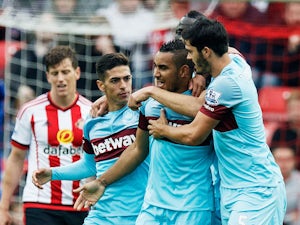 Dimitri Payet (2nd R) of West Ham United celebrates scoring his team's second goal with his team mates during the Barclays Premier League match between Sunderland and West Ham United at the Stadium of Light in Sunderland on October 3, 2015