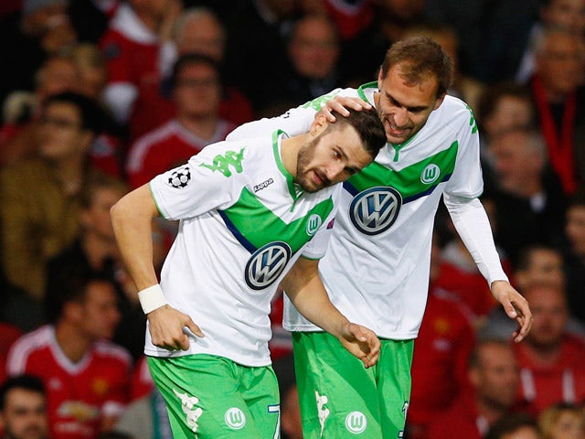 Daniel Caligiuri of VfL Wolfsburg (L) celebrates with Bas Dost as he scores their first goal during the UEFA Champions League Group B match between Manchester United FC and VfL Wolfsburg at Old Trafford on September 30, 2015