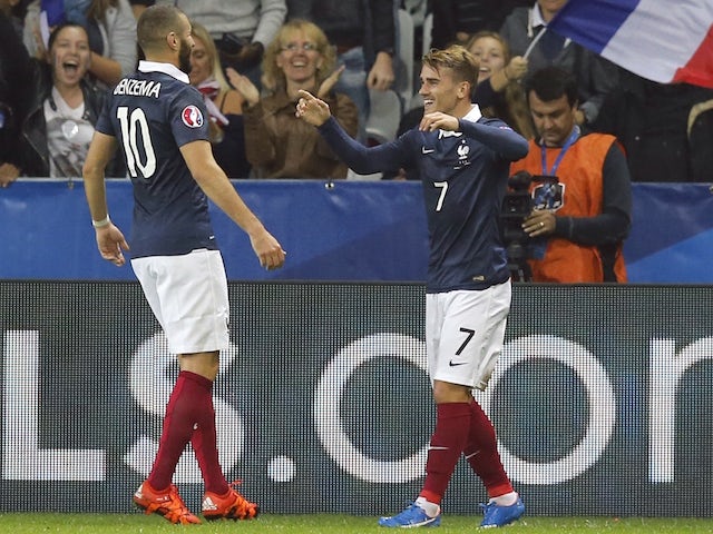 France's forward Antoine Griezmann (R) celebrates with France's forward Karim Benzema after scoring a goal during the friendly football match between France and Armenia on October 8, 2015 at the Allianz Riviera stadium in Nice, southeastern France. 