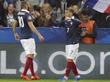 France's forward Antoine Griezmann (R) celebrates with France's forward Karim Benzema after scoring a goal during the friendly football match between France and Armenia on October 8, 2015 at the Allianz Riviera stadium in Nice, southeastern France. 