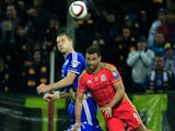 Hal Robson-Kanu (R) of Wales jumps for the ball against Toni Sunjic (L) of Bosnia of the Euro 2016 qualifying football match between Bosnia and Herzegovina and Wales at the Stadium Bilino Polje in Elbasan on October 10, 2015.