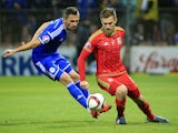 Aaron Ramsey (R) of Wales in action against Anel Hadzic (L) of Bosnia during the Euro 2016 qualifying football match between Bosnia and Herzegovina and Wales at the Stadium Bilino Polje in Elbasan on October 10, 2015.