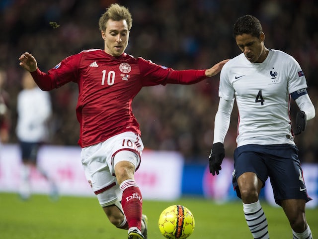 Denmark's midfielder Christian Eriksen (L) and France's defender Raphael Varane vie for the ball during a friendly international football match between Denmark and the hosts of the Euro 2016 France at Parken arena in Copenhagen on October 11, 2015.