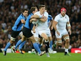 Owen Farrell of England is tackled during the 2015 Rugby World Cup Pool A match between England and Uruguay at Manchester City Stadium on October 10, 2015 in Manchester, United Kingdom.