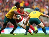 Gareth Davies of Wales takes on Tevita Kuridrani (L) of Australia during the 2015 Rugby World Cup Pool A match between Australia and Wales at Twickenham Stadium on October 10, 2015