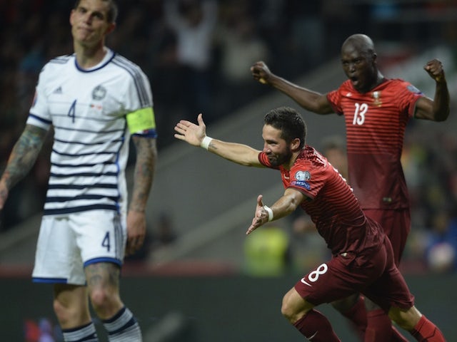 Portugal's midfielder Joao Moutinho (C) celebrates with teammate midfielder Danilo Pereira (R) next to Denmark's defender Daniel Agger after scoring a goal during the Euro 2016 qualifying football match Portugal vs Denmark at the Municipal stadium in Brag