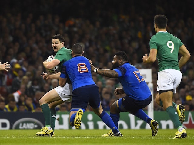 France's number 8 Louis Picamoles (C) tackles Ireland's fly half Jonathan Sexton (2L) during a Pool D match of the 2015 Rugby World Cup between France and Ireland at the Millennium Stadium in Cardiff, south Wales, on October 11, 2015.