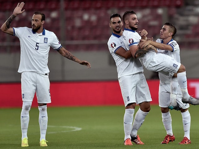 Greece's Kostas Stafylidis (2nd R) is lifted by teammate after he scored during the UEFA Euro 2016 qualifying Group F football match between Greece and Hungary at the Stadio Georgios Karaiskakis in Athens on October 11, 2015.