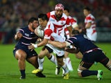 Kotaro Matsushima of Japan is held back during the 2015 Rugby World Cup Pool B match between USA and Japan at Kingsholm Stadium on October 11, 2015 in Gloucester, United Kingdom.