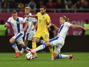Lucian Sanmartean (L) of Romania is tackled by Markus Halsti of Finland during the UEFA EURO 2016 Qualifier between Romania and Finland on October 8, 2015 in Bucharest, Romania.