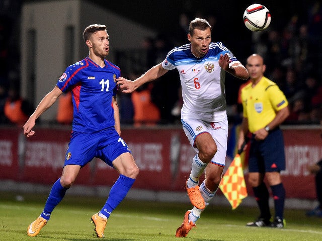 Russia's defender Aleksei Berezutski (R) vies Moldova's forward Nicolae Milinceanu during the Euro 2016 qualifying football match between Russia and Moldova at the Stadionul Zimbru in Chisinau on October 9, 2015.