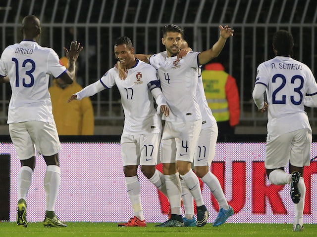 Nani (C) of Portugal celebrates scoring a goal with team mates Miguel Veloso (R) and Danilo (L) during the Euro 2016 qualifying football match between Serbia and Portugal at the Stadium FC Partizan in Belgrade on October 11, 2015.