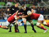 New Zealand's flanker Sam Cane (C) is tackled by Tonga's lock Tukulua Lokotui during a Pool C match of the 2015 Rugby World Cup between New Zealand and Tonga at St James' Park in Newcastle-upon-Tyne, northeast England, on October 9, 2015