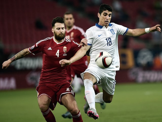 Greece's Petros Mantalos (R) vies for the ball with Hungary's Tamas Kadar during the UEFA Euro 2016 qualifying Group F football match between Greece and Hungary at the Stadio Georgios Karaiskakis in Athens on October 11, 2015.