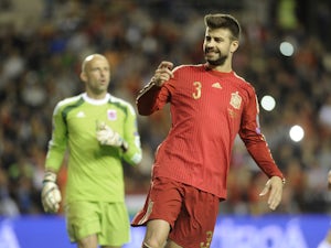 Defender Gerard Pique (R) grimaces during the Euro 2016 qualifying football match Spain vs Luxembourg at Las Gaunas stadium in Logrono on October 9, 2015