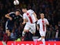 Russell Martin of Scotland is challenged by Robert Lewandowski of Poland during the EURO 2016 Qualifier between Scotland and Poland at Hamden Park on October 8, 2015 in Glasgow, Scotland.