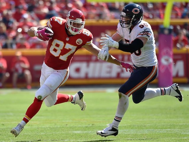 Travis Kelce #87 of the Kansas City Chiefs avoids a tackle attempt from Shea McClellin #50 of the Chicago Bears at Arrowhead Stadium during the game on October 11, 2015 in Kansas City, Missouri. 