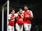 Aaron Ramsey of Arsenal (C) celebrates with Hector Bellerin (L) and Olivier Giroud (R) as he scores their third goal during the Barclays Premier League match between Watford and Arsenal at Vicarage Road on October 17, 2015 in Watford, England. 