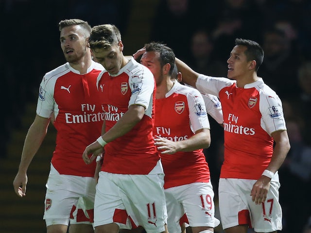 Alexis Sanchez of Arsenal (R) celebrates with team mates as he scores their first goal during the Barclays Premier League match between Watford and Arsenal at Vicarage Road on October 17, 2015 in Watford, England.