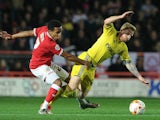 Chris Burke of Nottingham Forest is tackled by Korey Smith of Bristol City during the Sky Bet Championship match between Bristol City and Nottingham Forest at Ashton Gate on October 16, 2015 in Bristol, England. 