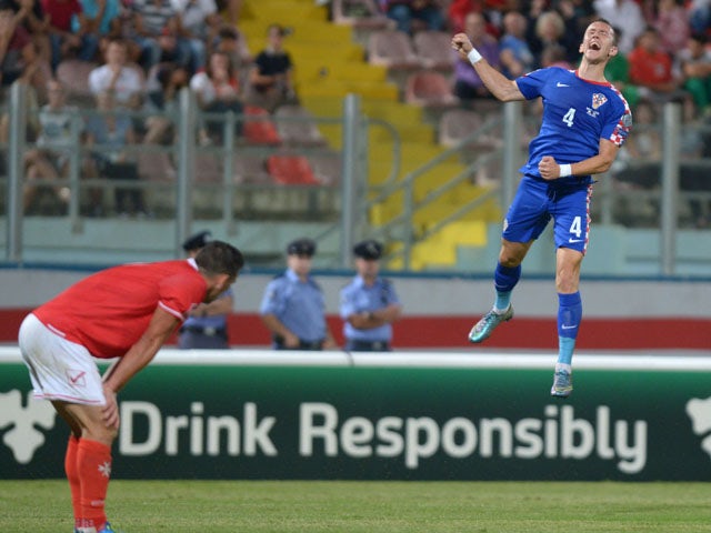 Croatia's Ivan Perisic (R) celebrates after scoring during the Euro 2016 qualifying football match between Malta and Croatia on October 13, 2015
