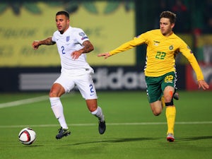 Kyle Walker of England is chased by Vytautas Andriukevicius of Lithuania during the UEFA EURO 2016 qualifying Group E match between Lithuania and England at LFF Stadionas on October 12, 2015