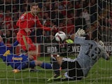 Wales's midfielder Aaron Ramsey scores a goal past Andorra's goalkeeper Ferran Pol Perez during the Euro 2016 qualifying football match between Wales and Andorra at Cardiff City stadium in Cardiff, south Wales, on October 13, 2015.