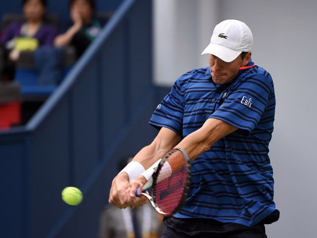 John Isner of the US hits a return to Adrian Mannarino of France during their men's singles first round match at the Shanghai Masters tennis tournament in Shanghai on October 12, 2015