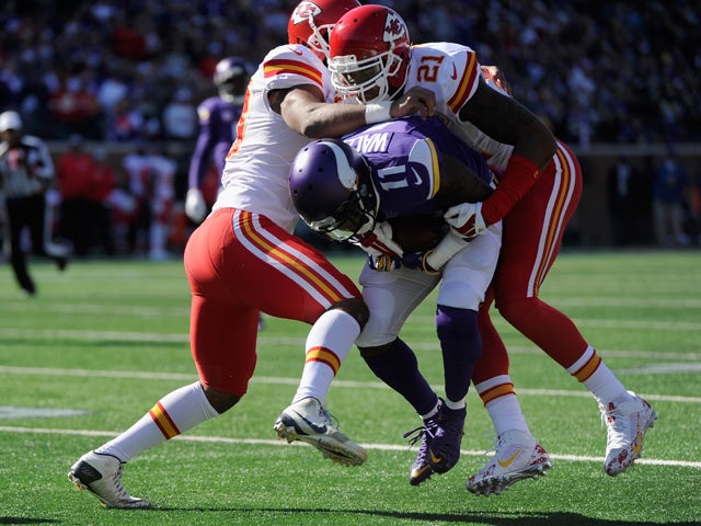 Ramik Wilson #53 and Sean Smith #21 of the Kansas City Chiefs stop the progress of Mike Wallace #11 of the Minnesota Vikings during the first quarter of the game on October 18, 2015