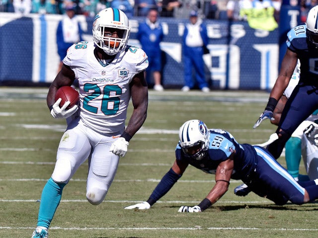 Lamar Miller #26 of the Miami Dolphins rushes against the Tennessee Titans during the first half of a game at Nissan Stadium on October 18, 2015